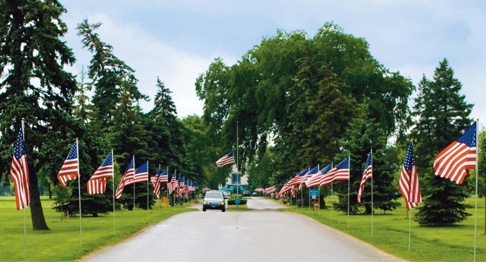 American flags lining the White Chapel Memorial Park roadway